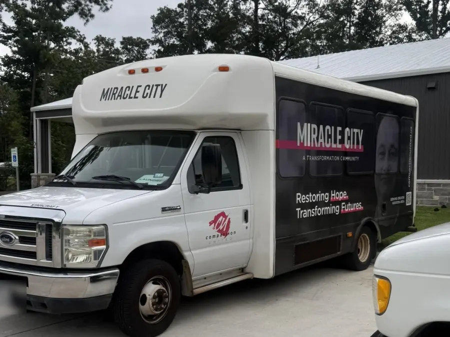 Compassion United's Miracle City shuttle bus parked outside, after Smoking Aces got its A/C working again