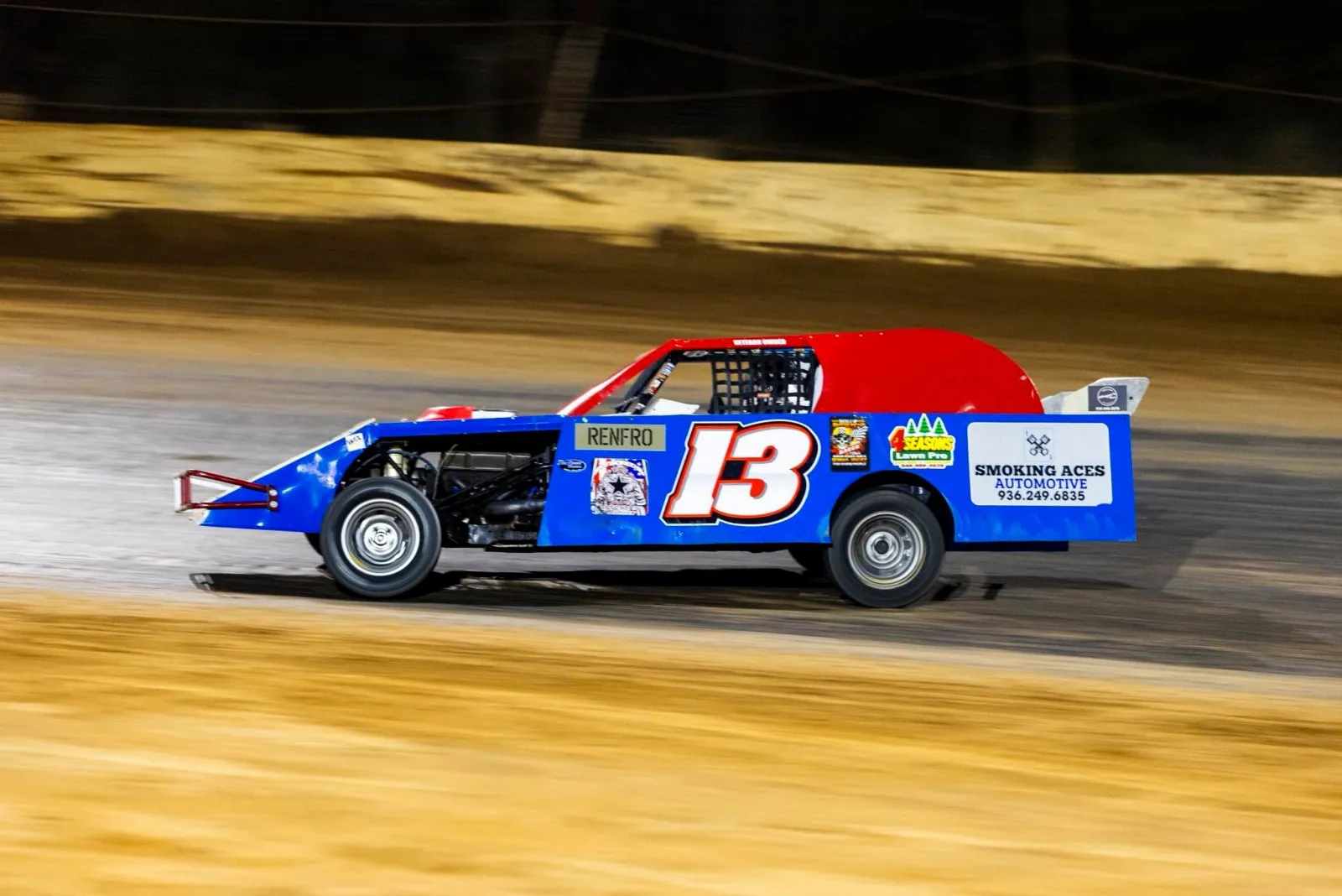 The #13 Renfro dirt-track car at speed, with a Smoking Aces Automotive sponsor decal on its side